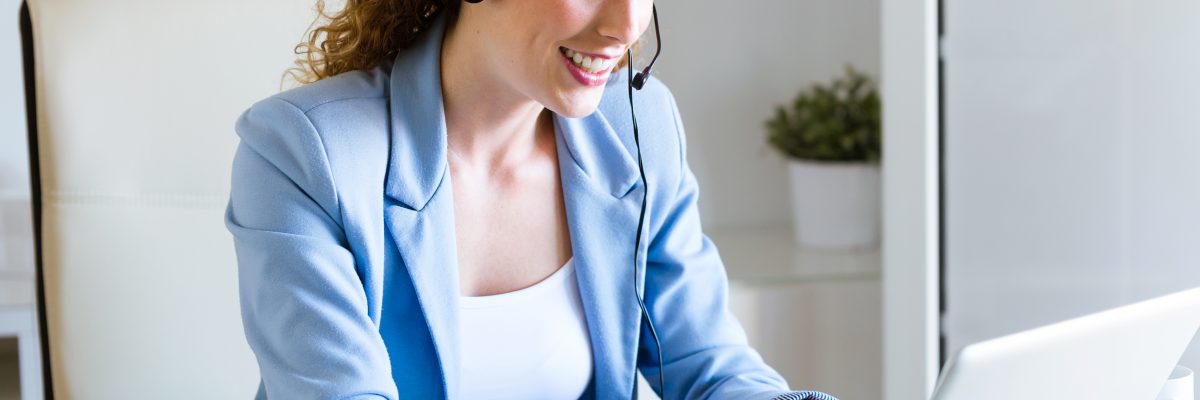 Portrait of customer service operator talking on phone in the office.